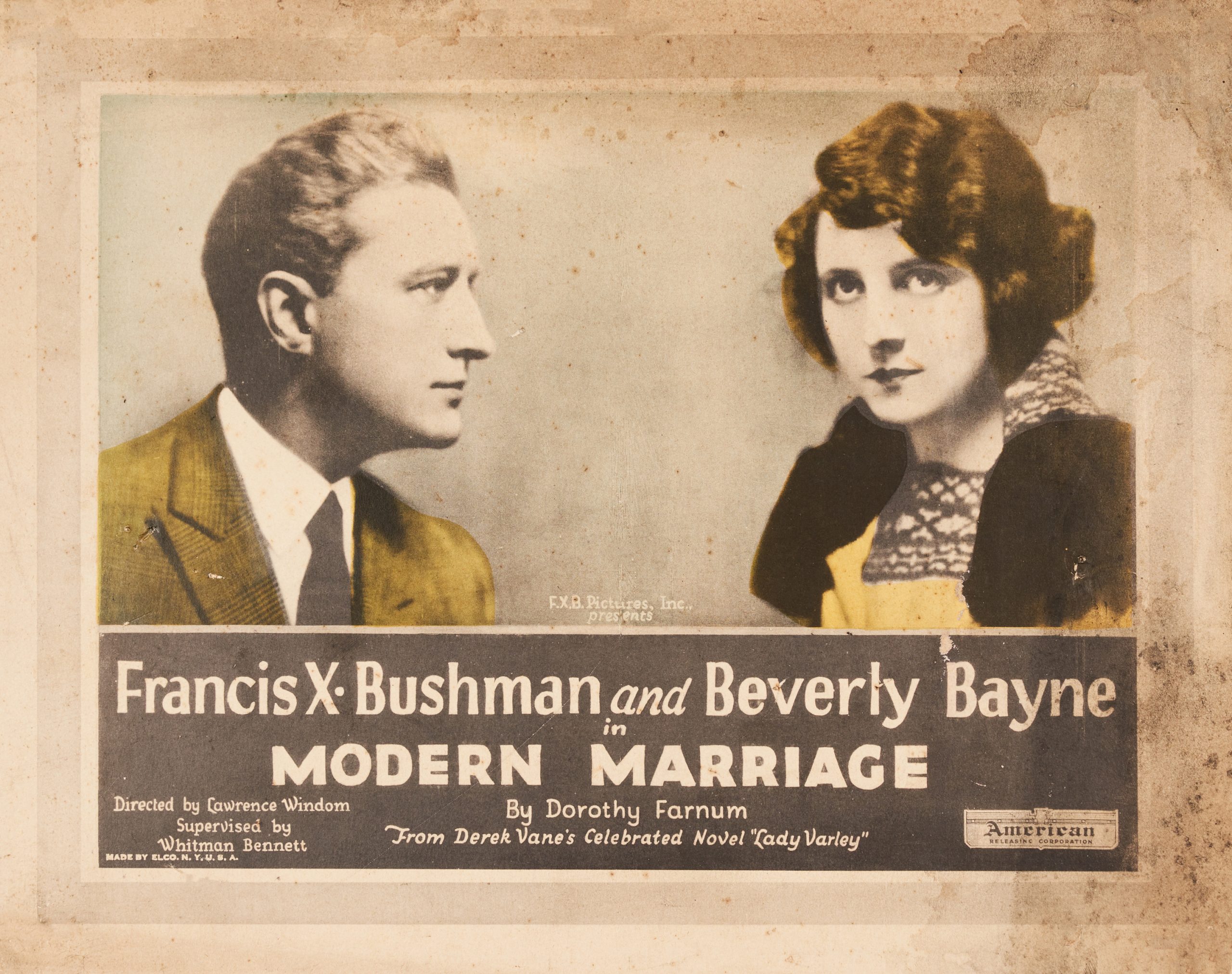 A lobby title card featuring portraits of the lead actor and actress with colored-in yellow accents.