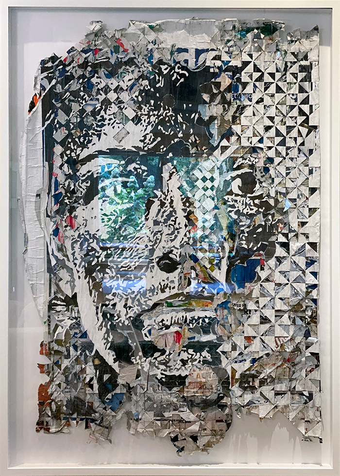 A collaged canvas featuring a face made up of cut outs from various posters.