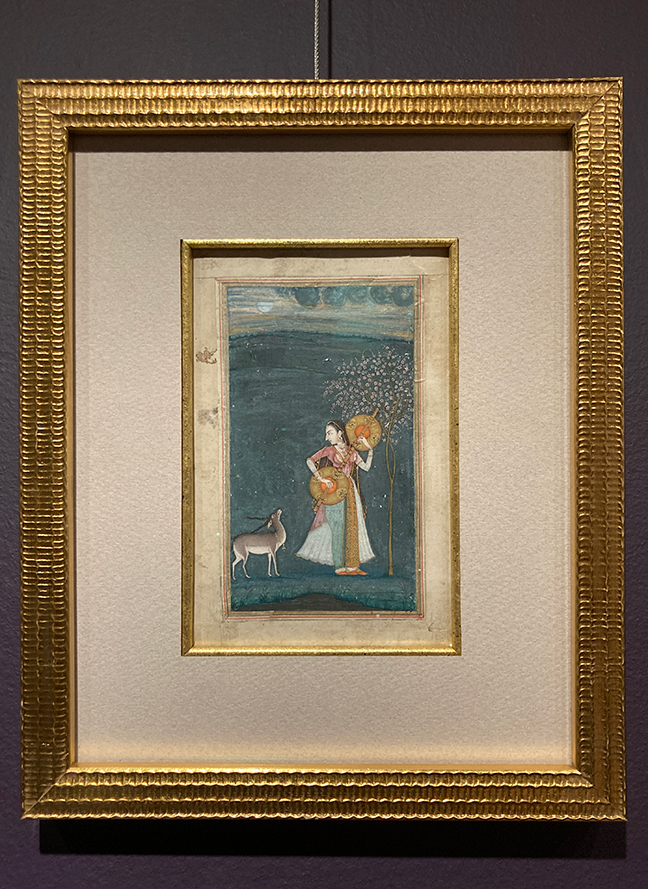 A watercolor painting of woman playing a veena in a field with a deer.