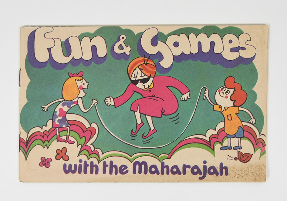 A booklet depicting a mustachioed figure wearing a turban playing jump ropes with two kids.