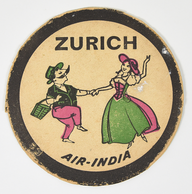 A coaster of a mustachiod figure wearing a green hat dancing with a woman from Zurich.