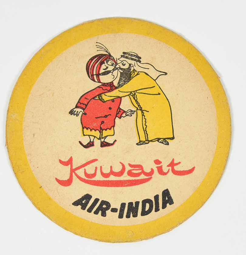A coaster of a mustachiod figure wearing a turban kissing a person from Kuwait on the cheek.