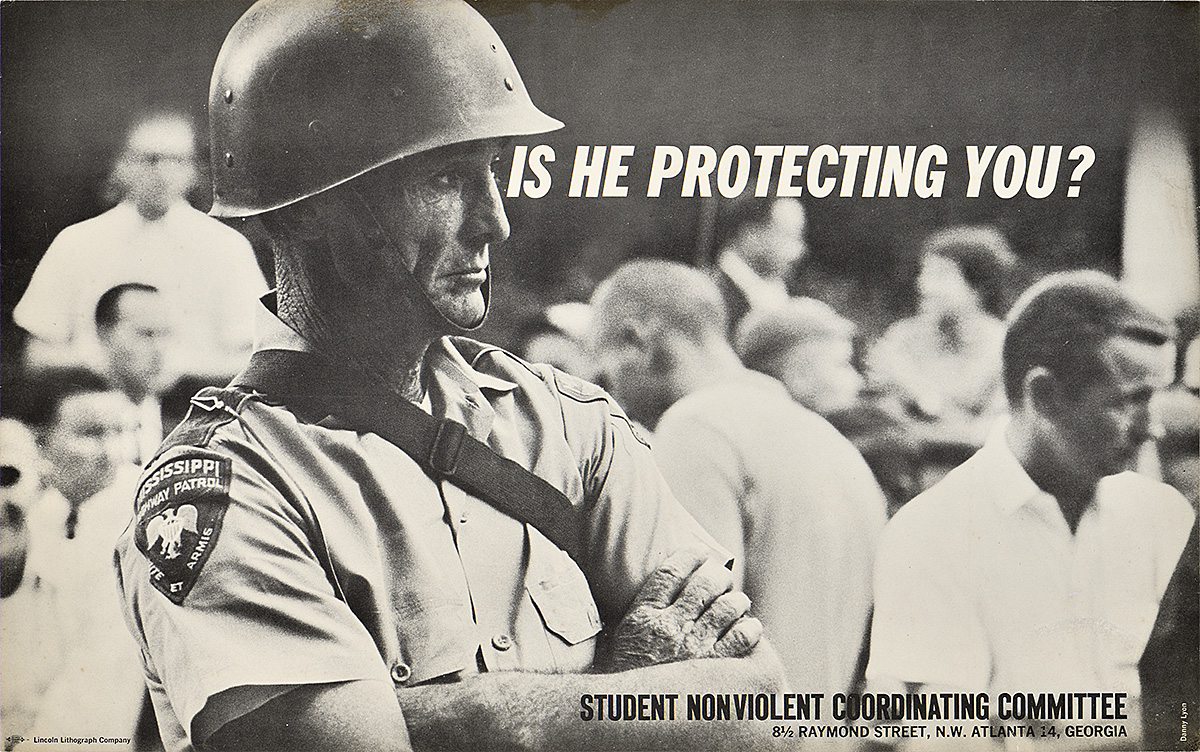 A photo offset poster of a white military officer with his arms crossed surrounded by a crowd.