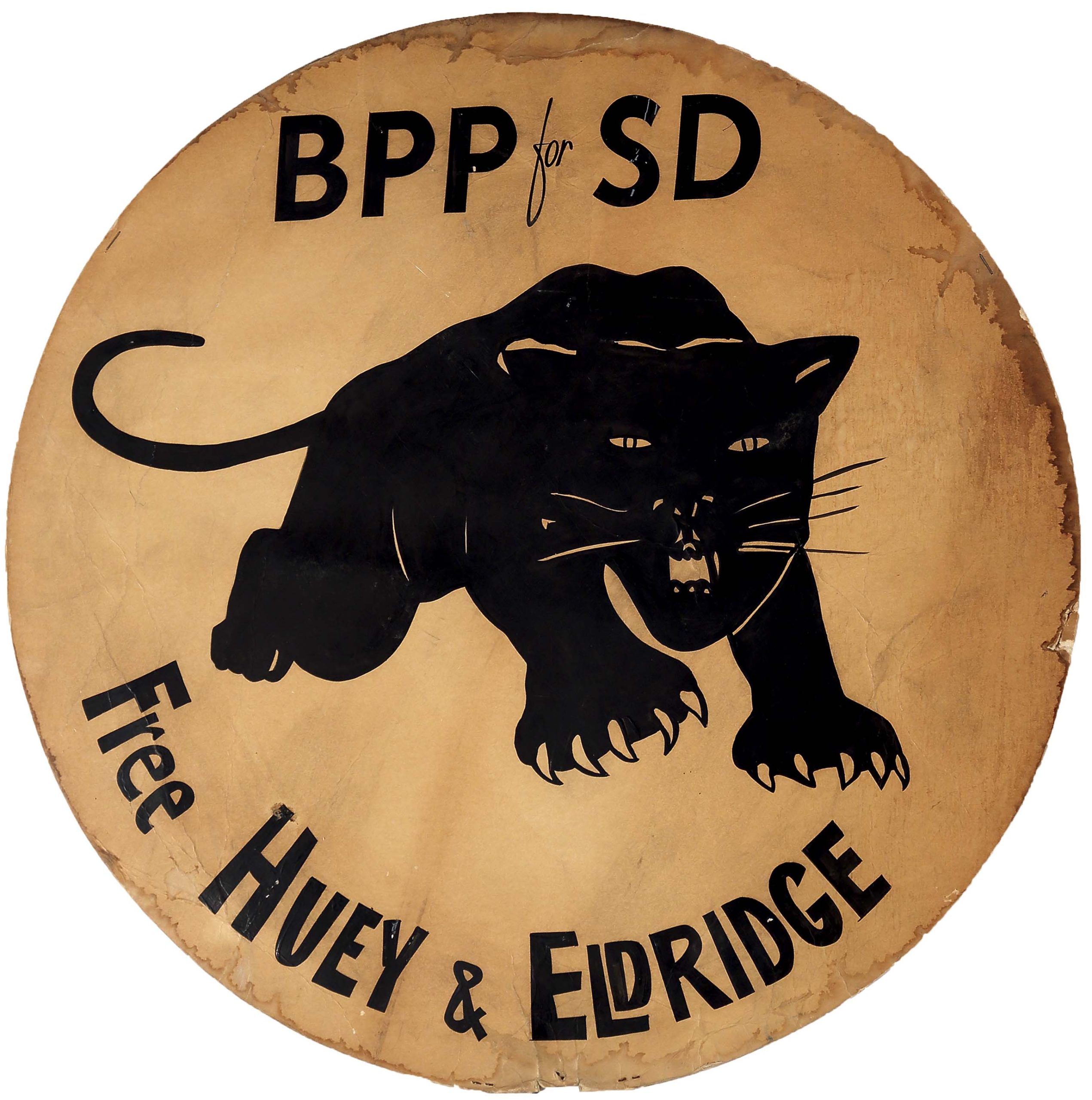 A double-sided sign of a black panther logo above the phrase “Free Huey & Eldridge.