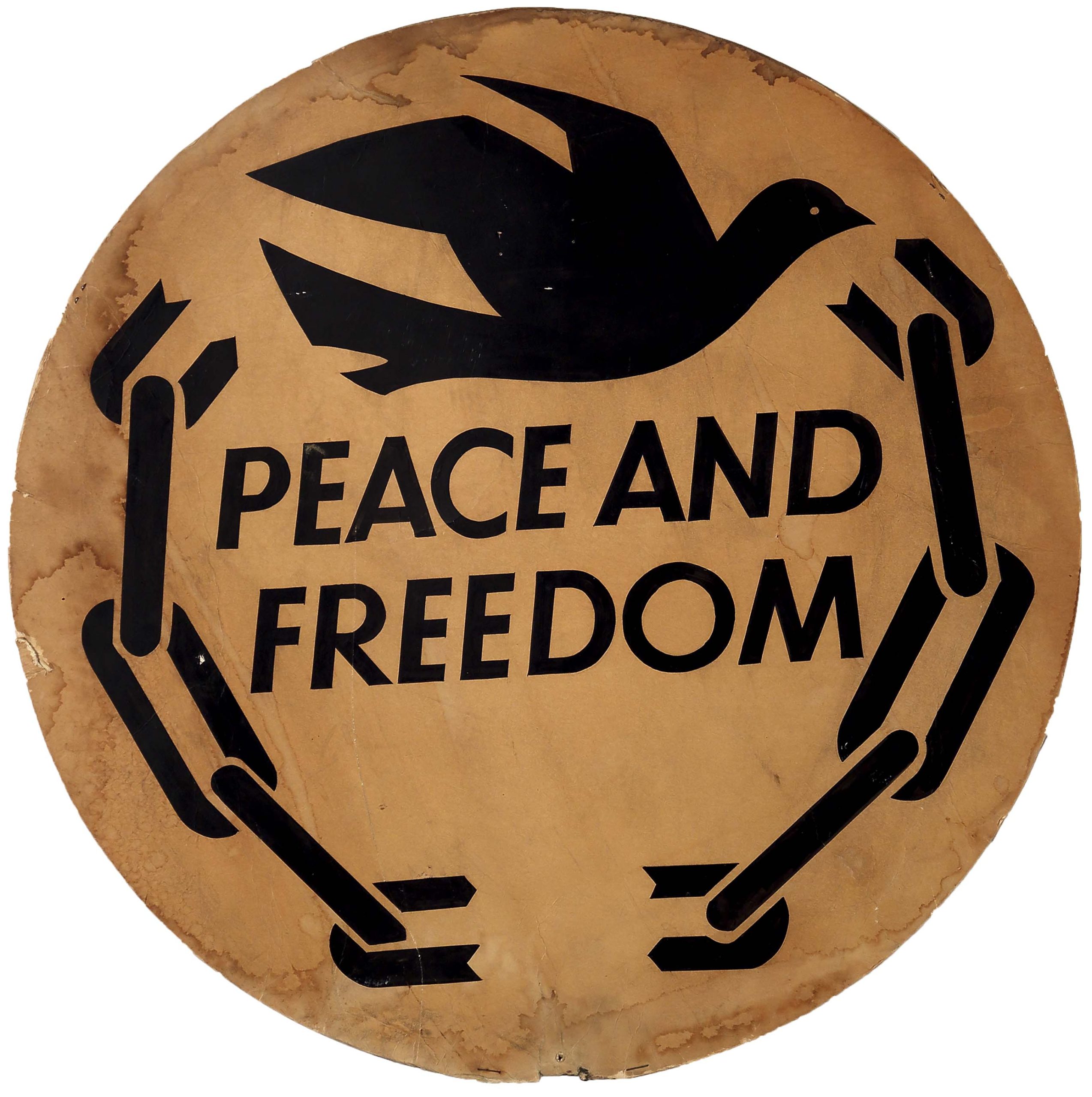 A double-sided sign of black dove logo flying between broken chains and text: 