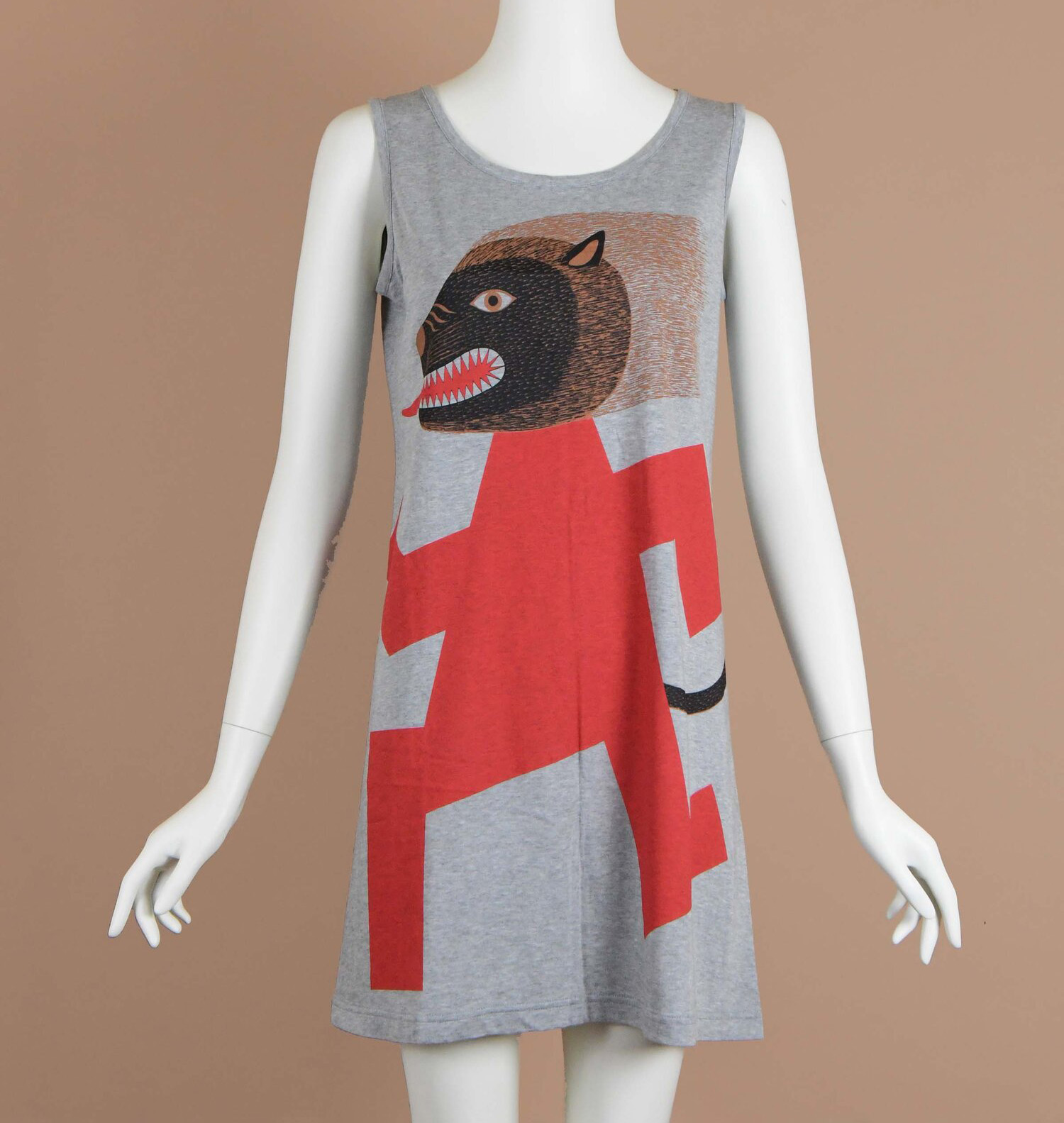 A dress featuring the design of a beast's head on a red stick figure's body.